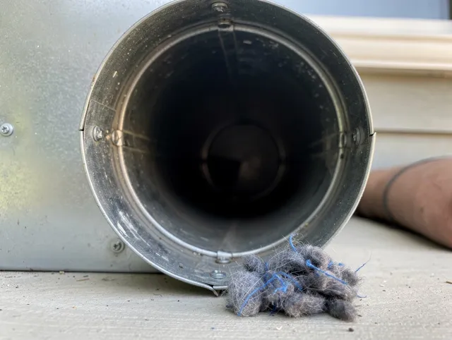 San Marino Dryer Vent Cleaning technician using specialized equipment to clear severe dryer vent blockage in San Marino